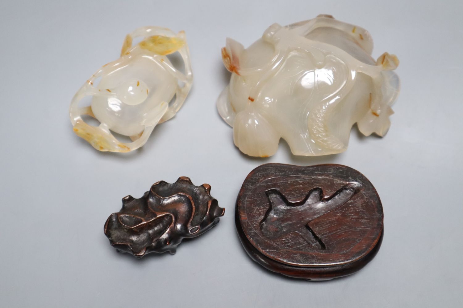 Two Chinese carved agate brushwashers on stands, largest 10cm